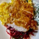 crispy turkey schnitzel with noodles and red cabbage salad
