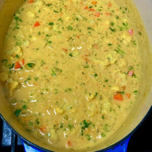 Blue pot of creamy yellow red lentil soup