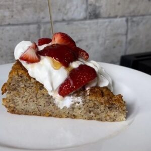 Lemon Olive Oil Cake with strawberries, whipped cream and drizzle of maple syrup