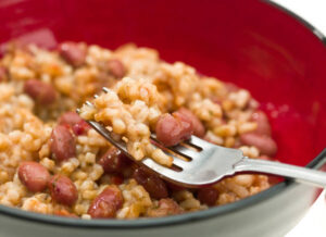 bowl with a fork lifting up rice & beans