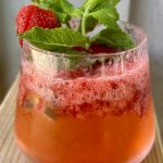strawberry shrub in a rocks glass garnished with fresh mint