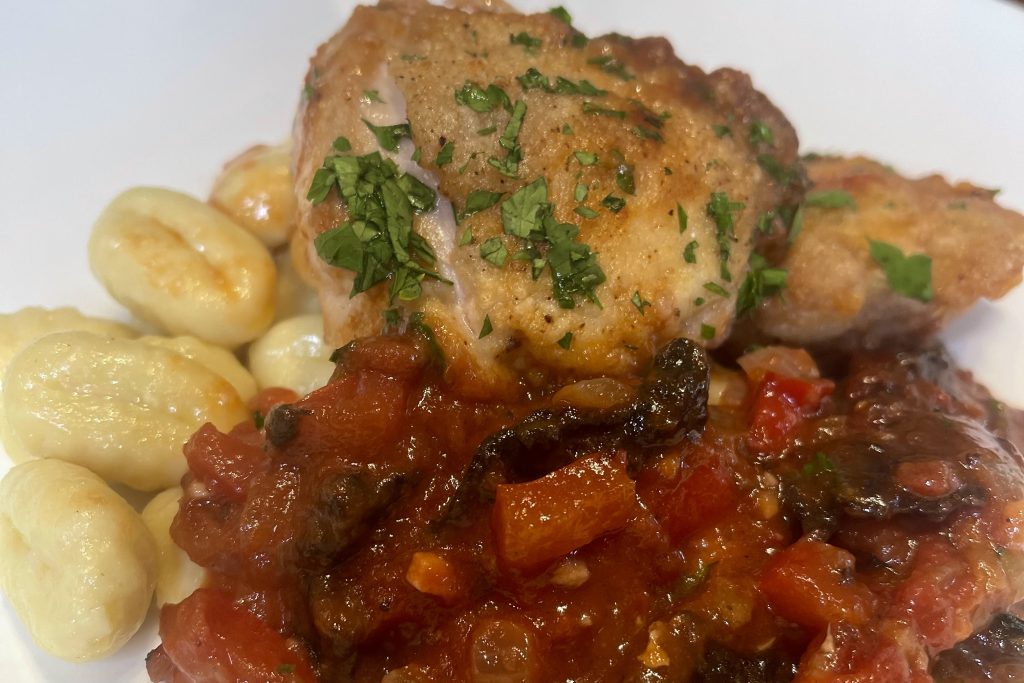 Chicken Cacciatore on a plate with gnocchi 
