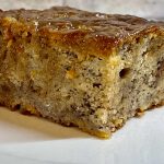 banana bread on a plate with brown sugar glaze