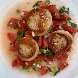 scallops on a plate with sauce vierge
