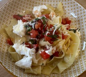 fresh pasta with sauce vierge, garnished with fresh mozzarella cheese