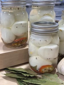Pickled eggs in a jar with spices