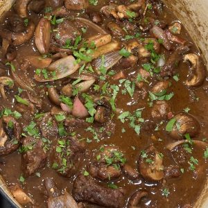 simmering beef bourguignon in a pot