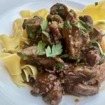 plate of beef bourguignon with noodles